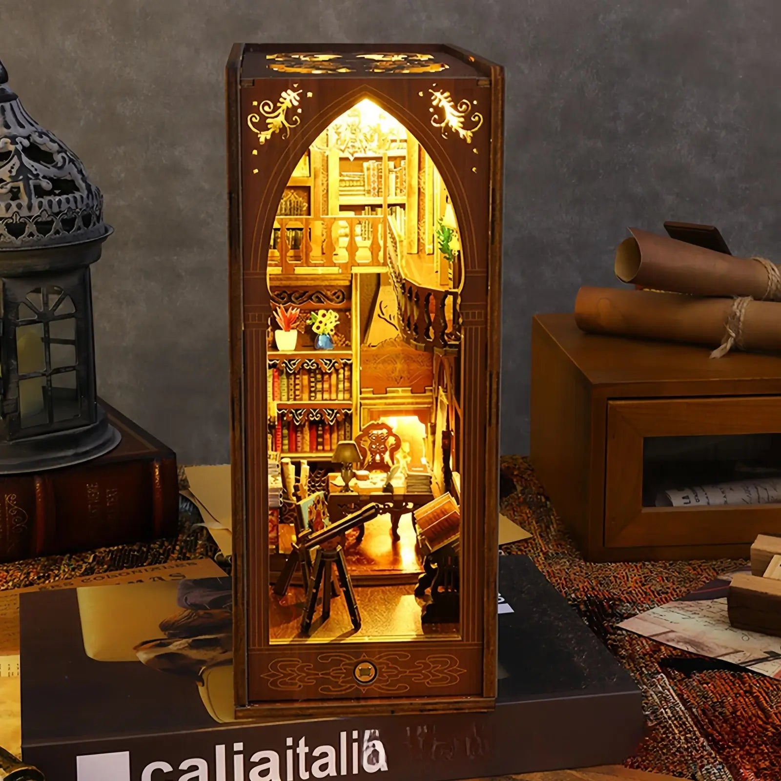 Front view of a miniature book nook detailing bookshelves and arranged books