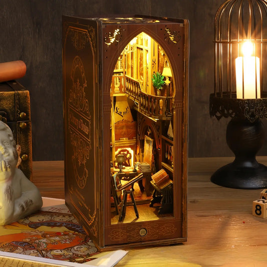 Side view of a miniature book nook showcasing intricate bookshelves and decorations inside
