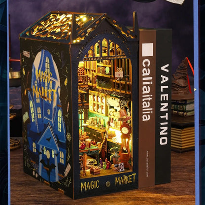 Magic Market book nook between two books on a shelf, showing its perfect fit. 